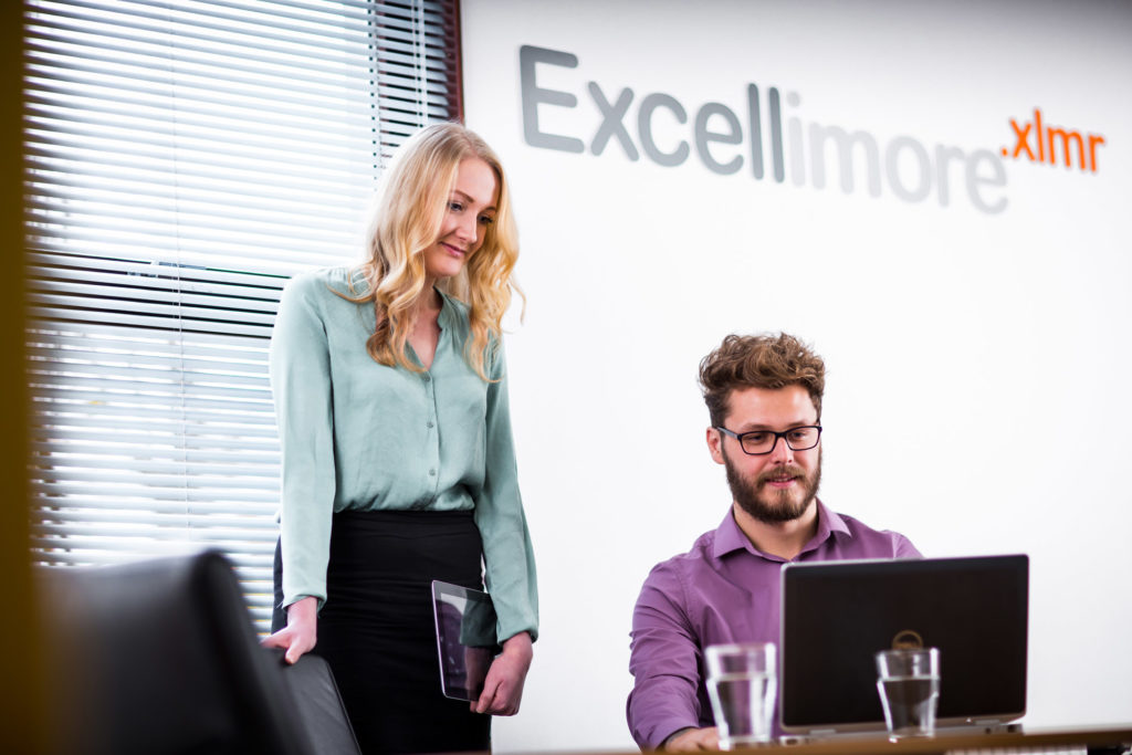 A woman and a man in the Excellimore boardroom