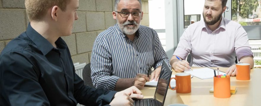 the Excellimore team sitting at a table