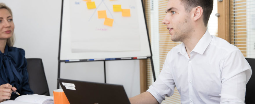 person, laptop, flipchart