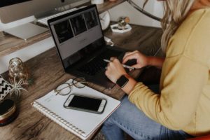 woman sitting at desk with laptop computer