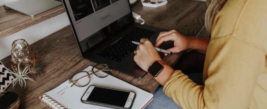 woman sitting at desk with laptop computer