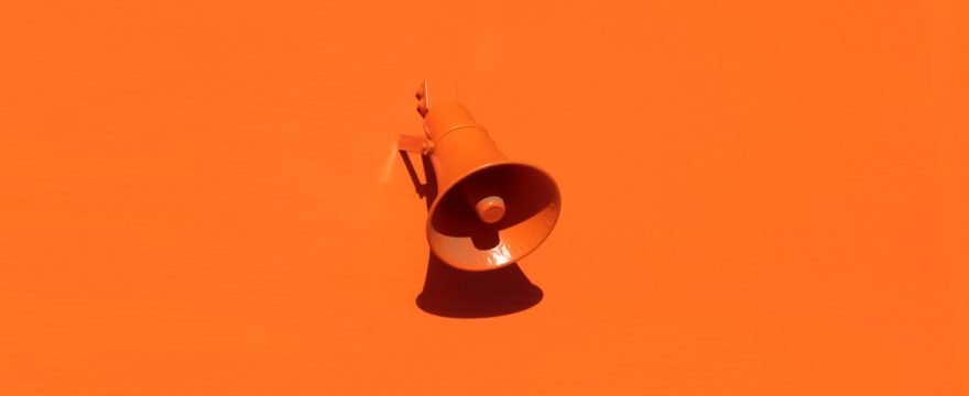orange loudspeaker on an orange wall